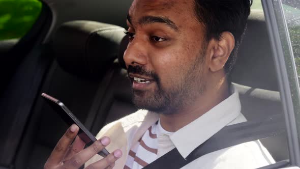 Male Passenger Calling on Smartphone in Taxi Car