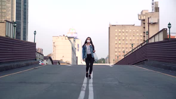 Girl Walks Bridge In Respirator