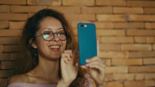 Happy Woman Enjoy Success on Mobile Phone. Joyful Woman Taping on Screen