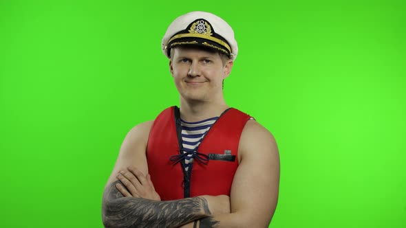 Young Muscular Sailor Man Works As Lifeguard at Beach Show Thumbs Up. Chroma Key