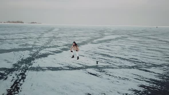 Stylish Young Woman Professional Dancer Dancing Energetic Jazz Funk or Hip Hop on Arctic Frozen Lake