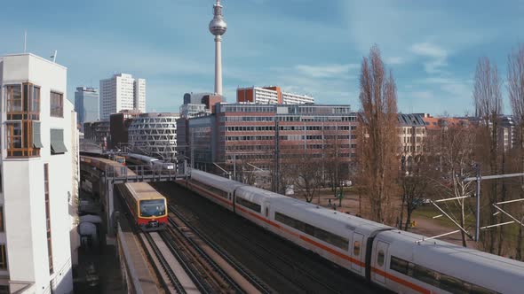 Scenic Aerial Shot of Passenger Train driving into city center