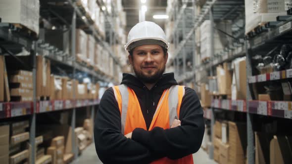 Portrait of Worker Warehouse Wearing Vest and Safety Helmet Standing in Retail Warehouse Full of