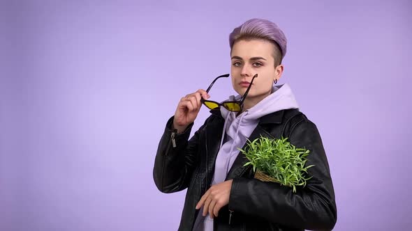 Bold LGBT Person Giving Cynical Look Putting on Sunglasses Isolated