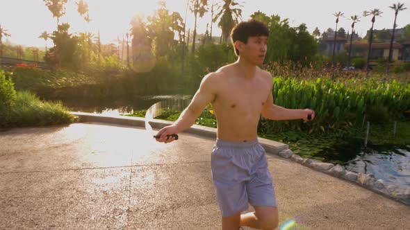 Young Asian man working out in a park in Los Angeles.