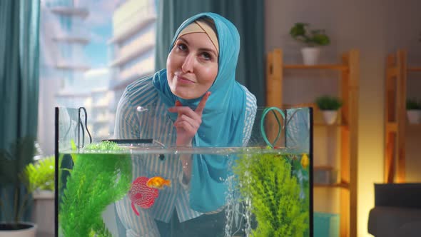 Pensive Muslim Woman at the Goldfish Aquarium