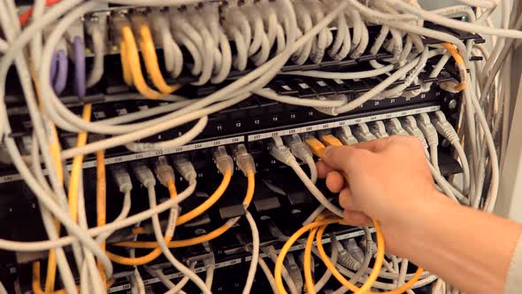 IT Engineer Patching Network Equipment In Server Room.Network Engineer Maintenance Lan Ethernet