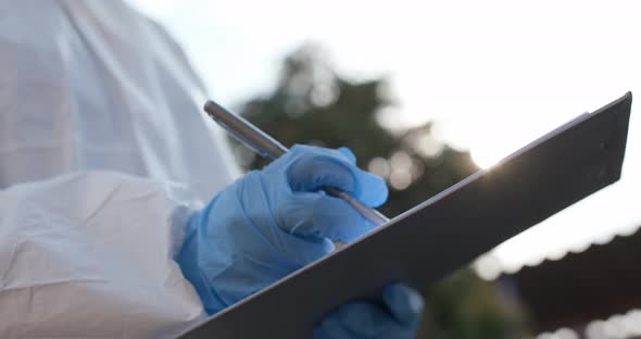 Doctor in Protective Suit Laboratory Assistant is Working on Creating a Vaccine