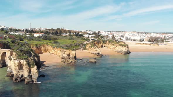 View From Estudante Beach to Farol de Lagos Molhe Este and Lagos Old Townscape, in Algarve