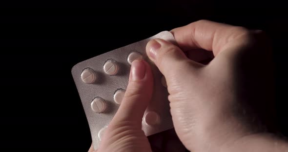 Pills In Hand on black background