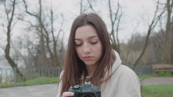 Happy Inspired Brunette Woman Making Photos in a Beautiful Park Leisure and Hobby Front View