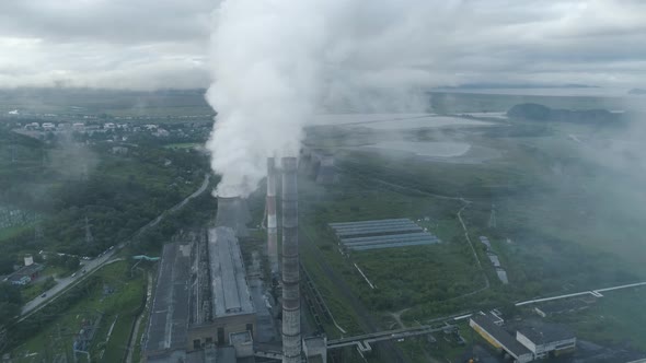 Aerial Drone View of Smoking Pipes and Cooling Towers of Coal Thermal Power Plant