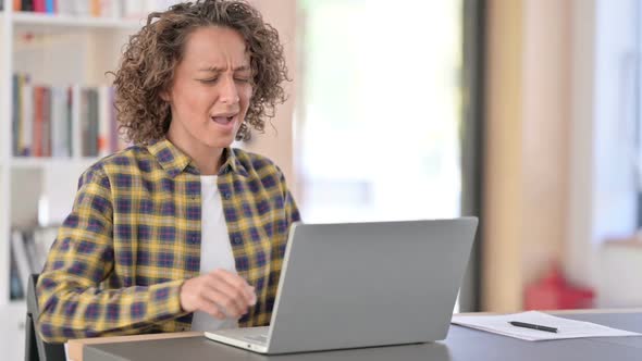 Tired Mixed Race Woman with Back Pain Using Laptop at Work