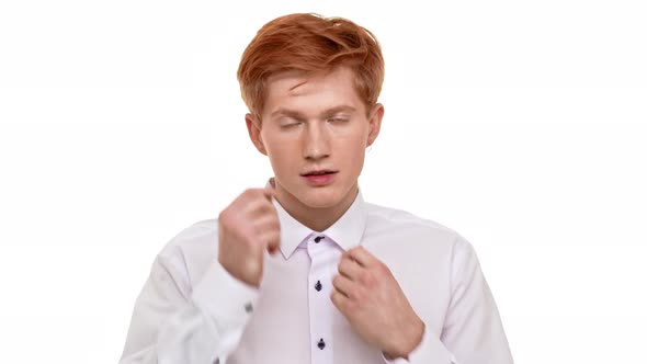 Young Confident Foxy Caucasian Man Straighten Collar and Doing Hair Up in Front of Camera on White