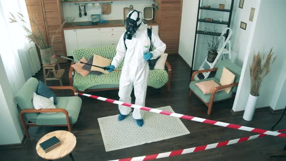 A Worker Disinfects Room, Spraying Antiseptic
