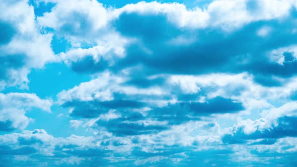 Timelapse White Fluffy Olakas Float Through the Blue Sky on a Sunny Day