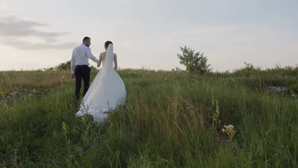 Happy Married Couple Walk in the Green Plants