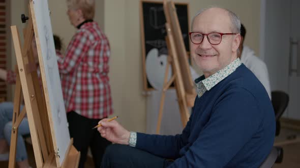 Portrait of Senior Man Enjoying Art Class to Develop Drawing Skills