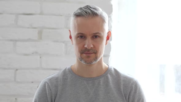 Portrait of Middle Aged Man Sitting in Office