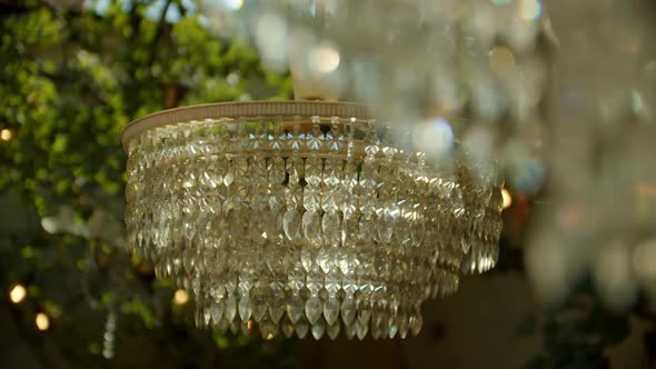 Chandelier Hanging on the Street in a Cozy Cafe or Country House Under an Awning Against the