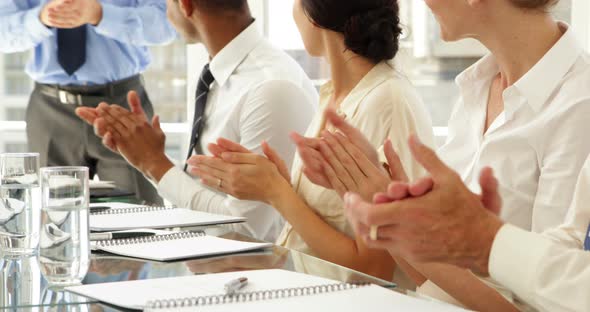 Business people clapping at presentation