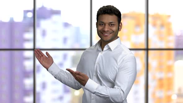 Young Happy Hindu Man Pointing Back with Both Hands