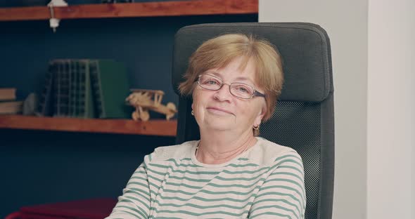 Portrait of an Elderly Woman in the Office