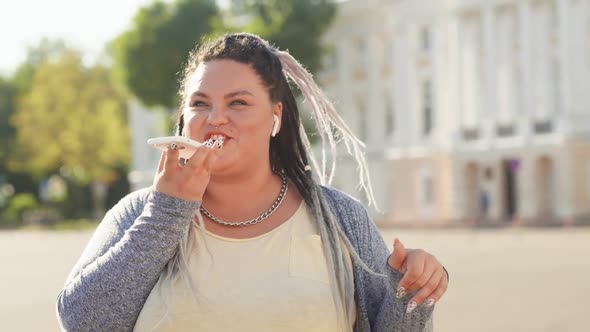 Happy Fat Woman Recording Audio Message Standing on Street at Sunny Summer Day. Creative Girl Using