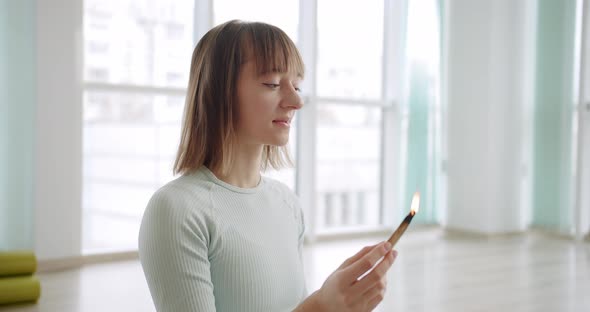 Woman Meditating with Palo Santo Holy Wood Relaxation Zen Practice in Studio