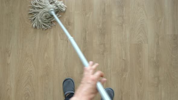 Young Adult Man Washing A Floor By Mop