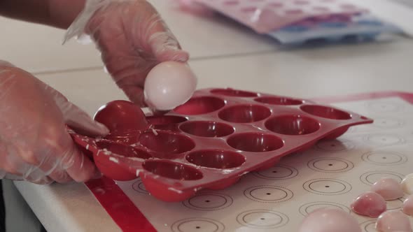 Woman Putting Out White Cream Molds From the Silicon Form