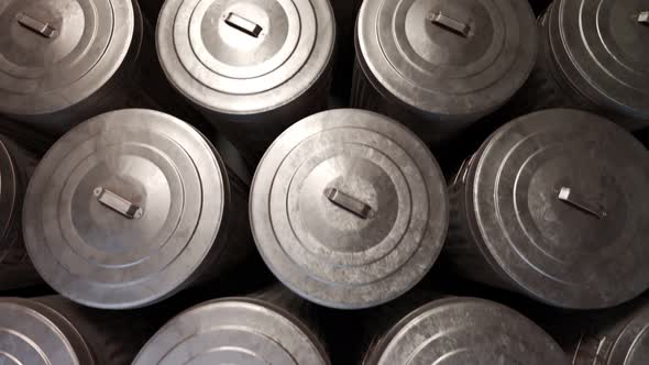 Steel trash bins stacked together in an endless loop lit by soft light. 4KHD