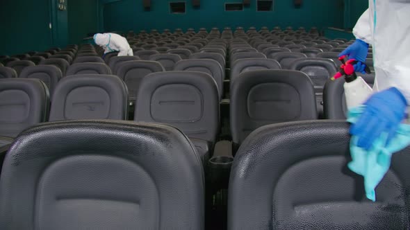 Workers Wiping Chairs with Rag and Dispenser