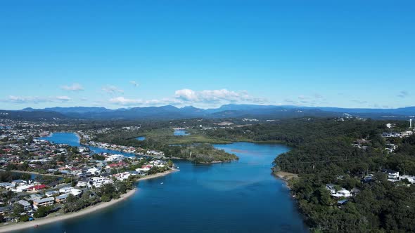 Scenic panorama of Tallebudgera Creek with the Gold Coast hinterland and cloud formation in the fore