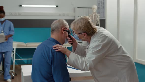 Medic Using Otoscope Instrument to Do Ear Examination