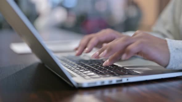 African Woman Hands Typing on Laptop