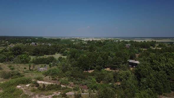 Beautiful aerial view of white painted steel lighthouse with red top located in Pape, Latvia at Balt