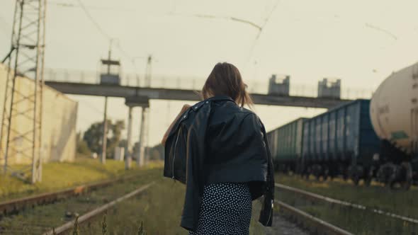 Beautiful Cinematic Footage with a Young Girl Dancing on the Railroad