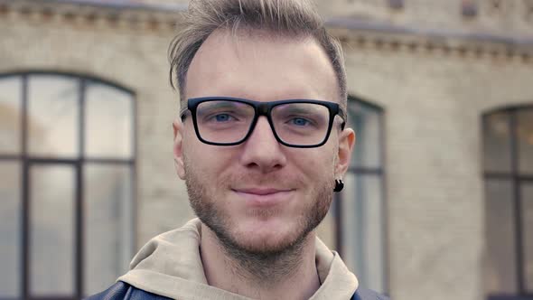 Emotional Video-portrait of a Nice Blue-eyed Man with Glasses