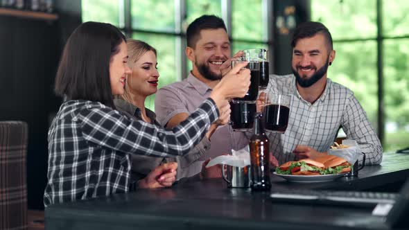 Smiling Man and Woman Enjoying Friendship Clinking Glasses Drinking Refreshing Beer