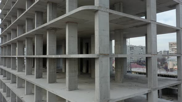 Aerial view of city residential area with high monolithic apartment building under construction