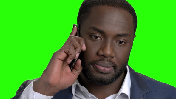 Smiling Dark-skinned Man Talking on Phone