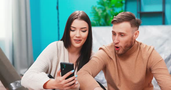 Married Couple Use Smartphone Choose Items Decor for New House Search Renovation Ideas on Internet