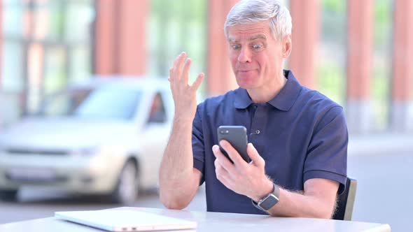 Outdoor Upset Middle Aged Businessman Get Shocked on Smartphone