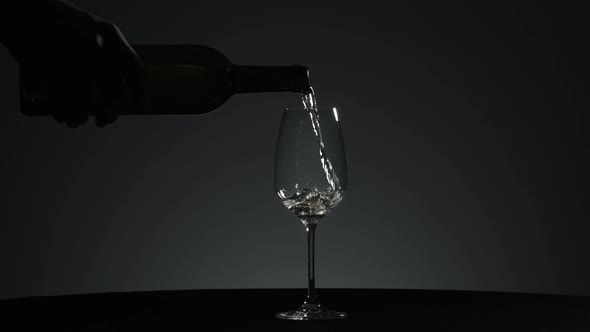 White Wine is Poured Into a Wine Glass