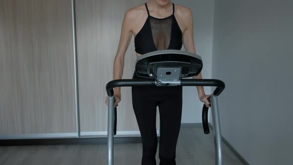 Attractive Woman Running at Home on a Treadmill