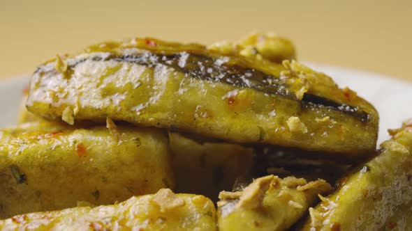 Tempura Aubergine Slices with Spicy Spices and Cane Sugar Syrup on Grey Plate Rotating Close Up