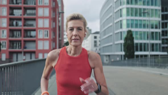 Active Mature Woman Running on City Street