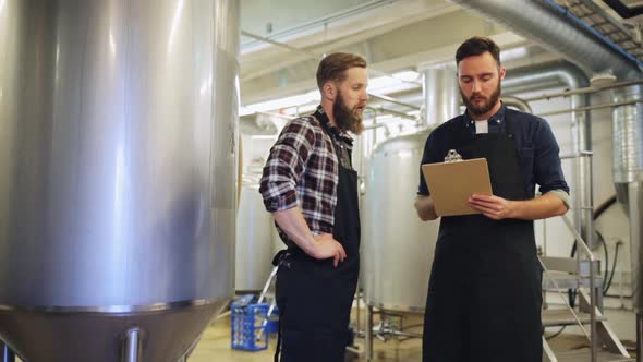 Brewers with Clipboard at Brewery or Beer Plant