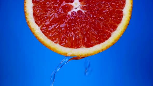 Freshness and Coolness of Juicy Grapefruit Juice or Water is Pouring From Fruit Closeup